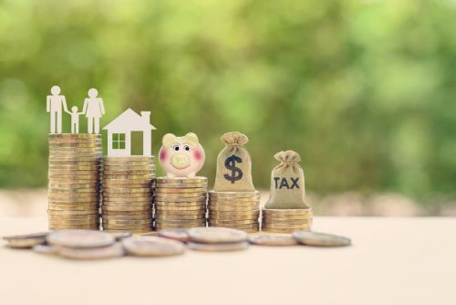 stacked coins topped with family, home, savings, cash, and taxes visual concept for blog discussing when you need an estate probate lawyer.