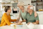 Adult daughter visiting her senior parents at home. Visual concept of a estate planning blog discussing why a Power of Attorney is so important for elderly parents.